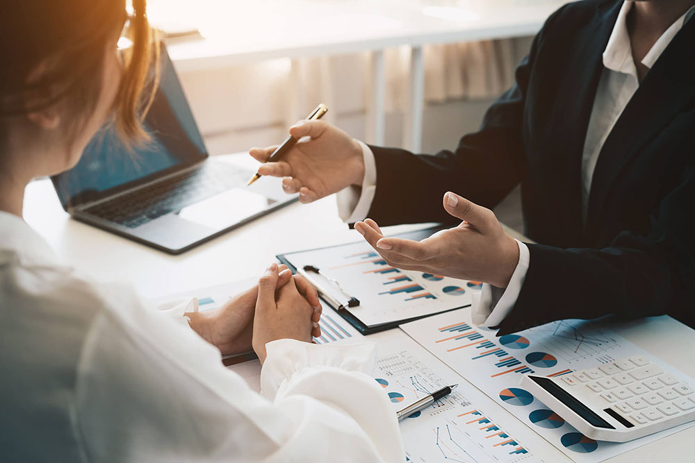 Advisor discussing plan of investment of financial report to clients